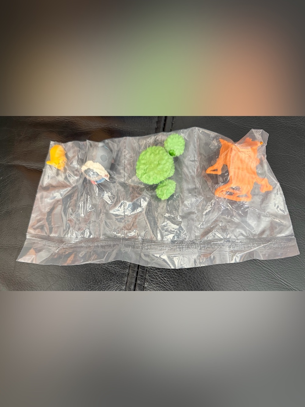 Set of Four Small Toy Figures - Green, Orange, Yellow, Black/White